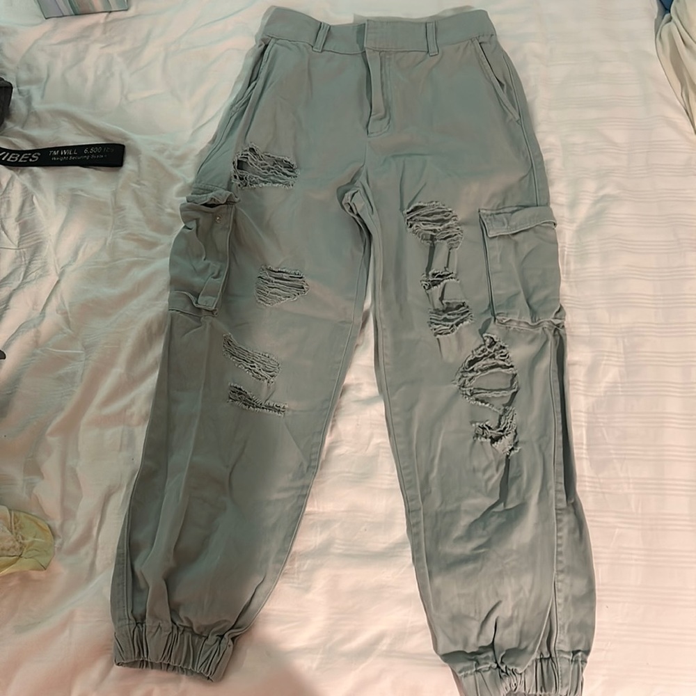 Forever 21 cropped teal ripped cargo pants with an elastic waist.